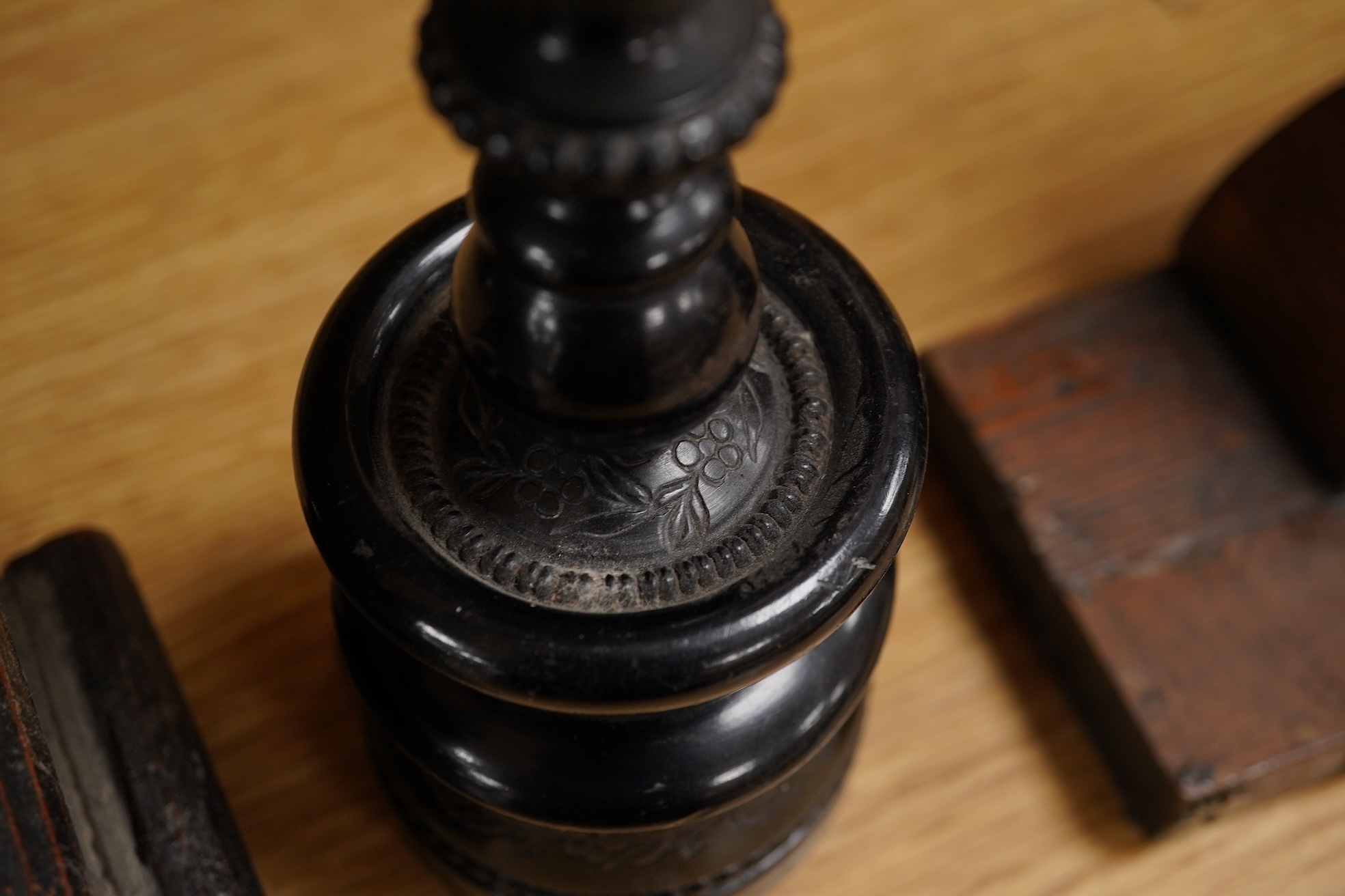 Two 19th century walnut and mother-of-pearl inlaid crucifixes and a German ebonised and white and metal mounted crucifix and a pair of Dutch or German brass tripod base cricket candlesticks, largest 56cm high (5)